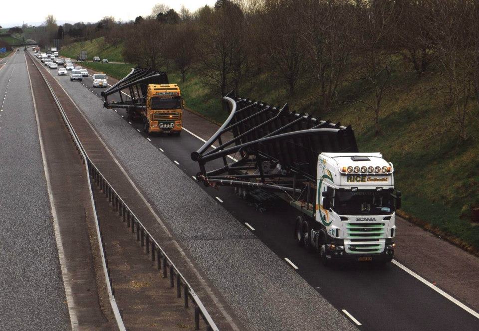 Escort and transport vehicles managing a long load.