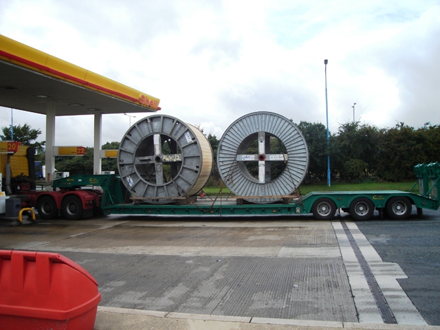 Large reels carried on an extendable low-loader.